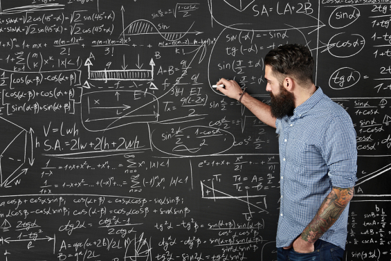 Bearded man draws formulas on a chalkboard